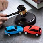 Midsection,Of,Judge,Hitting,Mallet,By,Cars,On,Table