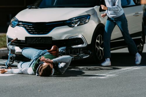 Cropped,Shot,Of,Woman,Running,To,Injured,Cyclist,At,Traffic