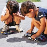 Toys,Cars,In,Front,Of,Children,Legs